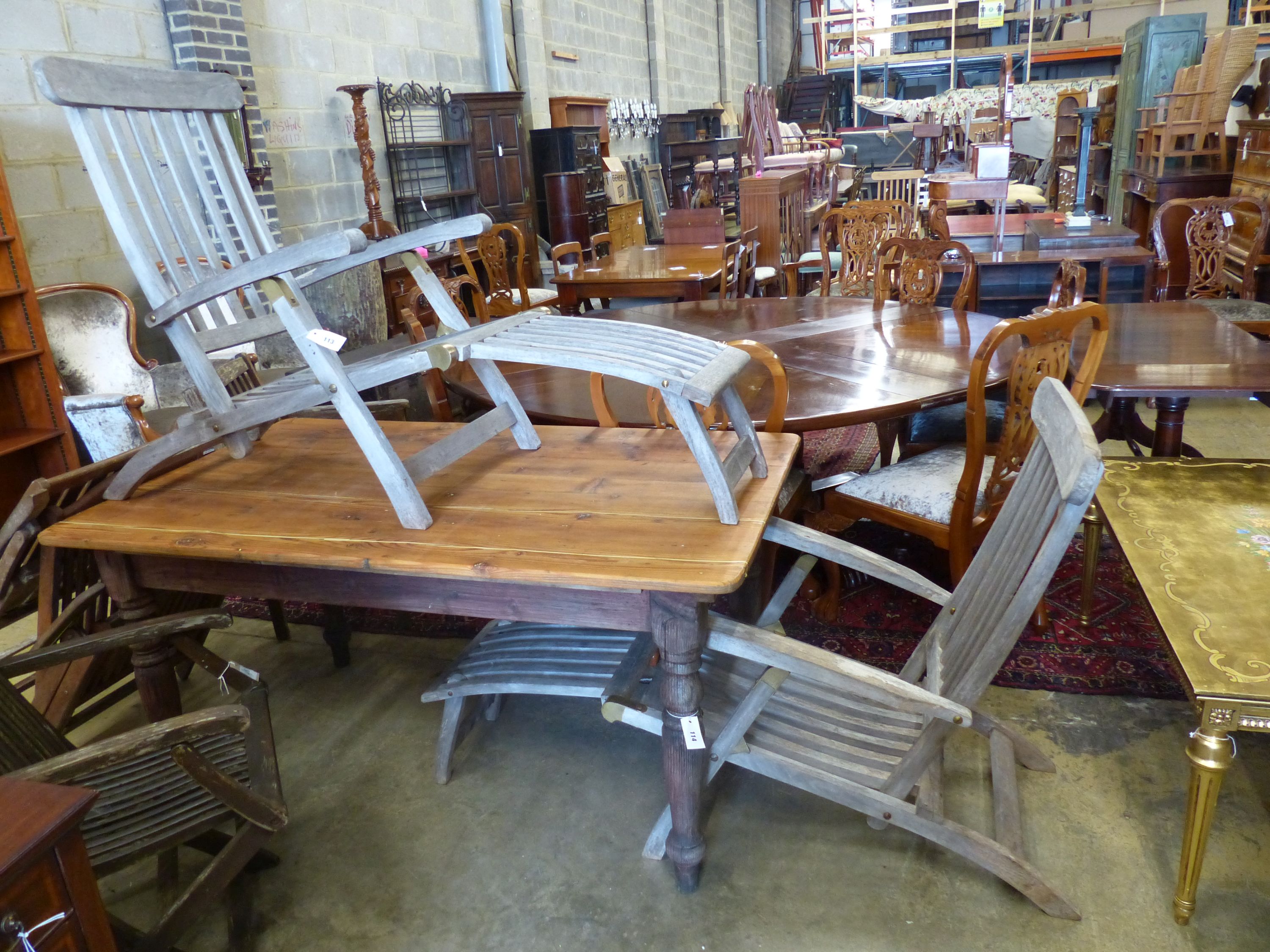 A pair of weathered teak garden steamer chairs, width 59cm, depth 150cm, height 98cm